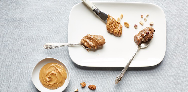 A selection of nut butters on a white plate